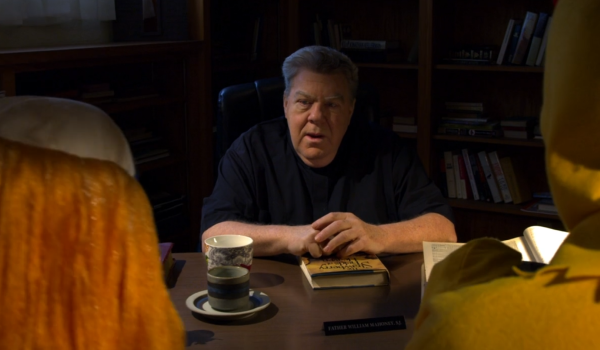 Movie still of George Wendt as Father Mahoney in Aliens, Clowns & Geeks (2022)