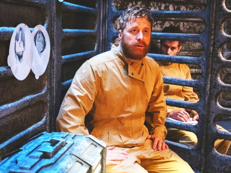 RESIDENT ALIEN Episode 1 “Prisoners” Review Television still of Alan Tudyk as Harry Vanderspeigle and Paul Piaskowski as Robert Hutchins in the Resident Alien episode "Prisoners"