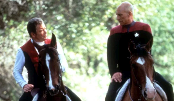 Patrick Stewart as Picard, and William Shatner as Kirk riding brown horses through a wooded area in Star Trek Generations (1994)