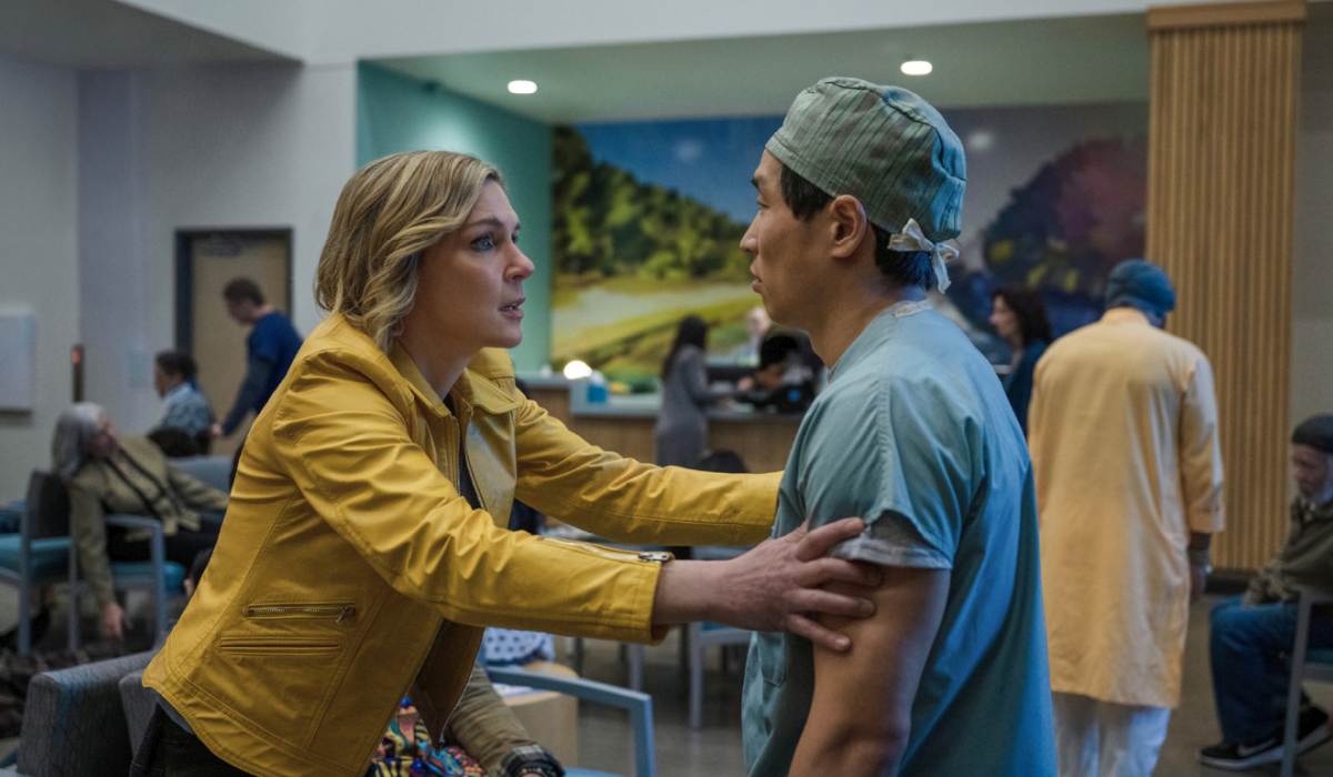 Television still of Rhea Seehorn as Carol Sturka and Woody Fu as Dave in the Pluribus episode "We Is Us"