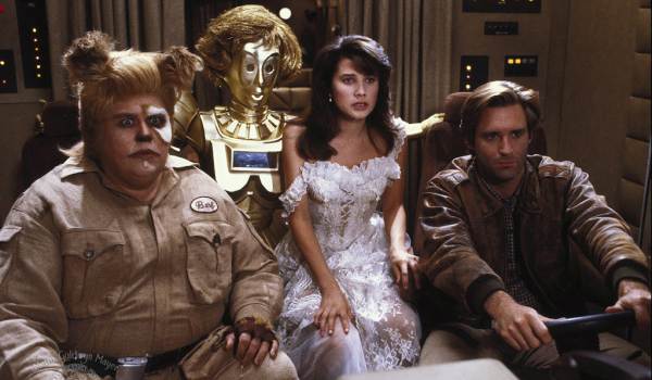 Movie still of John Candy as Barf, Joan Rivers as Dot Matrix (voice), Daphne Zuniga as Princess Vespa, and Bill Pullman as Lone Starr in the sci-fi movie Spaceballs (1987)