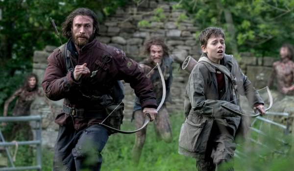Movie still of Aaron Taylor-Johnson as Jamie, and Alfie Williams as Spike in the sci-fi movie 28 Years Later (2025)