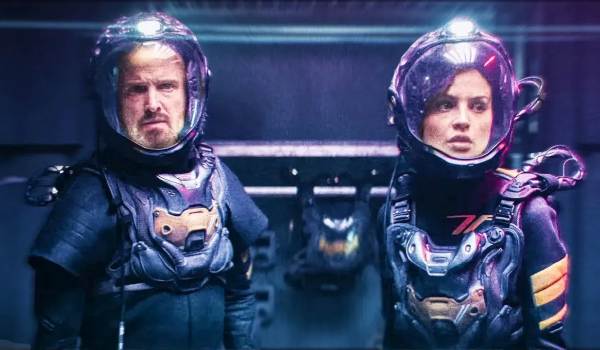 Movie still of Eiza González as Riya, and Aaron Paul as Brion in the sci-fi movie Ash (2025)