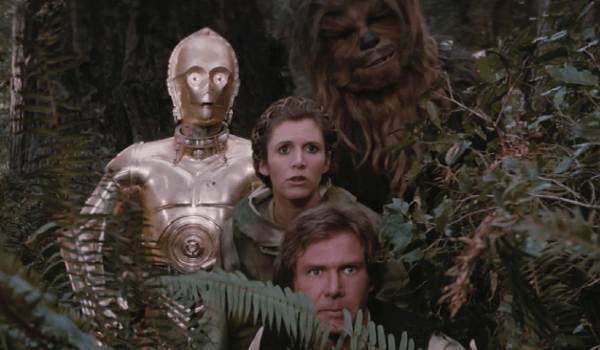 Movie still of Anthony Daniels as C-3PO, Carrie Fisher as Princess Leia, Peter Mayhew as Chewbacca, and Harrison Ford as Han Solo in the sci-fi movie Star Wars: Episode VI - Return of the Jedi (1983)