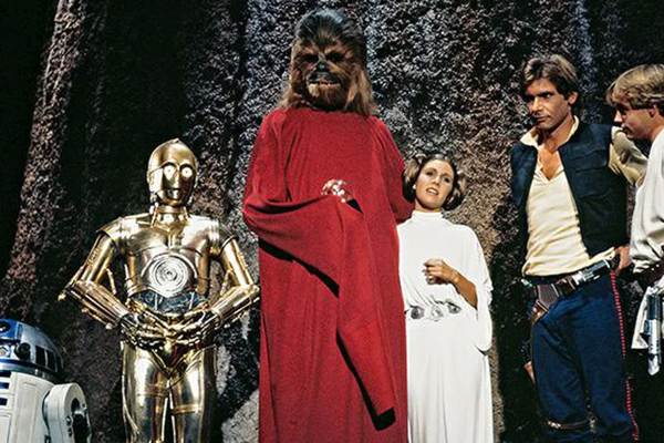 Movie still of Anthony Daniels as C-3PO, Peter Mayhew as Chewbacca, Carrie Fisher as Princess Leia Organa, Harrison Ford as Han Solo, and Mark Hamill as Luke Skywalker in the sci-fi movie The Star Wars Holiday Special (1978)