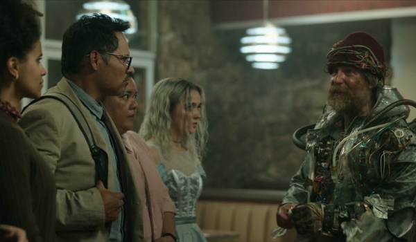 Movie still of Zazie Beetz as Janet, Michael Peña as Mark, Georgia Goodman as Marie, Haley Lu Richardson as Ingrid, and Sam Rockwell as Man From the Future in the sci-fi movie Good Luck, Have Fun, Don't Die (2026)