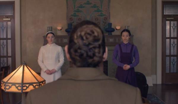 Television still of Lucy Halliday as Daisy, Ann Dowd as Aunt Lydia, Chase Infiniti as Agnes MacKenzie in the sci-fi show The Testaments