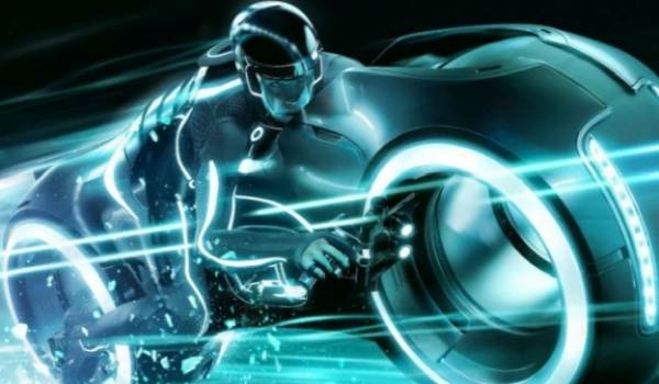 High-speed Light Cycle with bright white-blue glowing wheels and heavy motion blur.