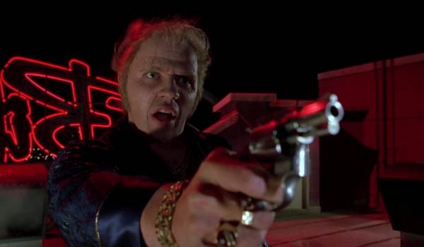 Movie still of Tom Wilson as Biff Tannen pointing a gun at Marty in Back to the Future Part II (1989)