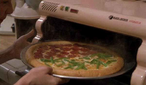 Movie still of Lea Thompson as Lorraine Baines taking a rehydrated Pizza Hut pizza from a Black & Decker Rehydrator in the sci-fi movie Back to the Future Part II (1989)