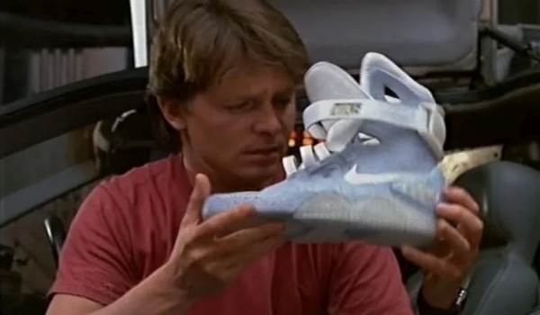 Movie still of Michael J. Fox as Marty McFly holding a futuristic sneaker in the sci-fi movie Back to the Future Part II (1989)