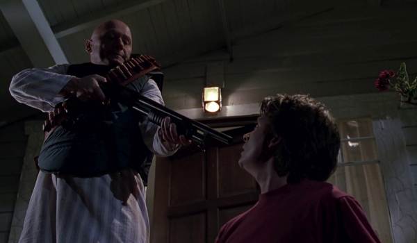Movie still of James Tolkan as S.S. Strickland pointing a shotgun at Michael J. Fox as Marty McFly in the sci-fi movie Back to the Future Part II (1989)
