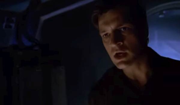 A still from the science fiction series Firefly showing Nathan Fillion as Captain Malcolm "Mal" Reynolds yelling on board his ship, the Serenity.