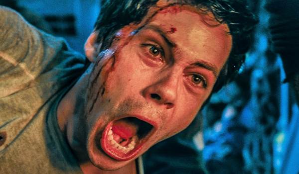 Dramatic close-up of Thomas (Dylan O'Brien) from Maze Runner: The Scorch Trials screaming Klunk, bloodied and shouting with an expression of distress or pain.