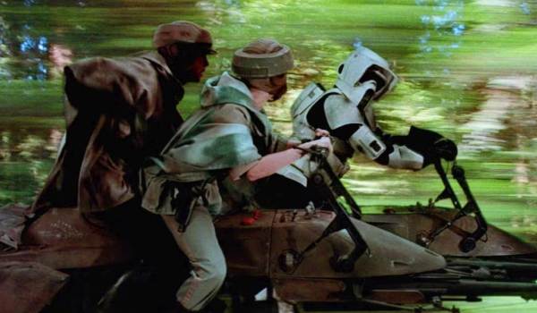  Mark Hamill as Luke Skywalker and Carrie Fisher as Princess Leia chasing a Scout Trooper on speeder bikes in a scene from Star Wars: Return of the Jedi.