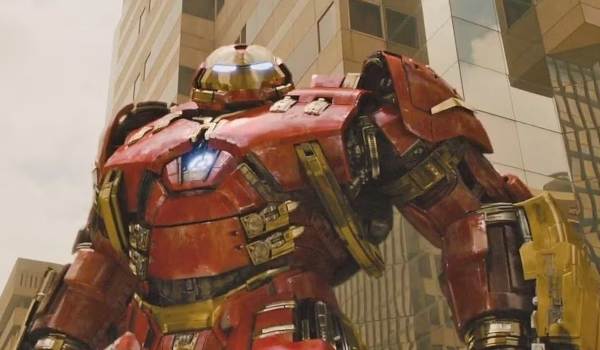 Iron Man in the Hulkbuster armor standing in front of a building in a scene from the 2015 film Avengers: Age of Ultron.