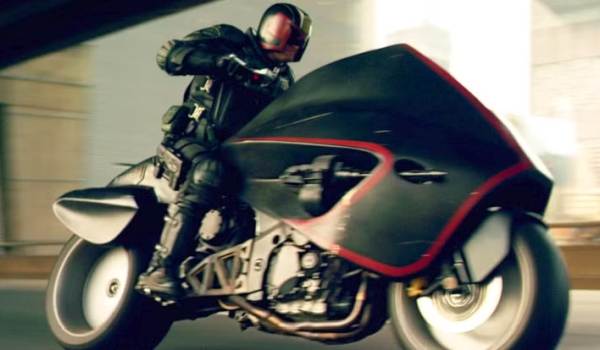  Judge Dredd riding the Lawmaster motorcycle through a tunnel in a scene from the 2012 film Dredd.