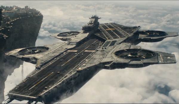 The S.H.I.E.L.D. Helicarrier soaring through the clouds near a floating landmass in a scene from the 2012 film The Avengers.