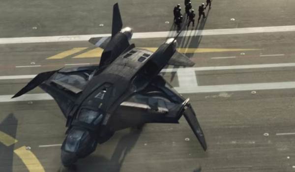 An Avengers Quinjet idling on the flight deck of the S.H.I.E.L.D. Helicarrier as personnel walk nearby in a scene from the 2012 film The Avengers.