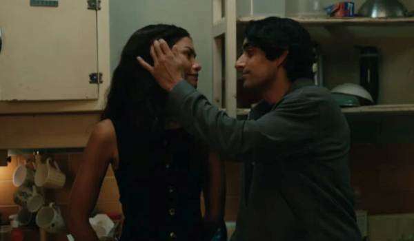 Eman Esfandi (as MJ’s new boyfriend) and Zendaya (as MJ) share an intimate moment in a kitchen in a scene from Spider-Man: Brand New Day.