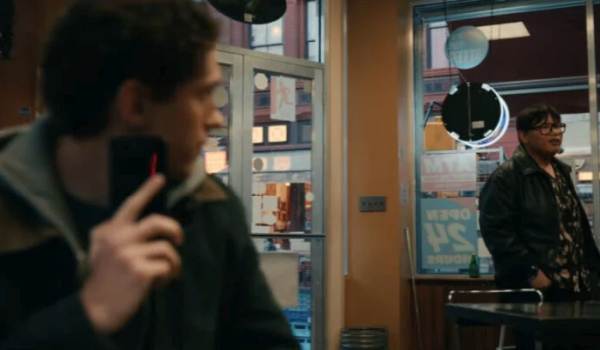 Tom Holland as Peter Parker looks back as Jacob Batalon (as Ned Leeds) enters a store in a still from Spider-Man: Brand New Day.