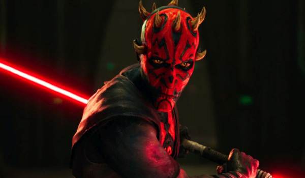 Maul, the Dathomirian Zabrak from Star Wars: Maul - Shadow Lord (2026), with red and black facial tattoos, igniting a double-bladed red lightsaber in a dark, atmospheric setting.