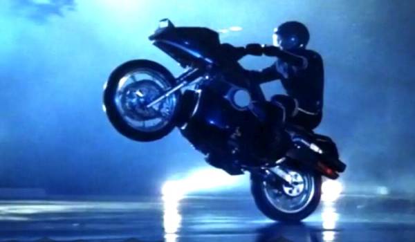 Rex Smith as Jesse Mach on the high-tech Street Hawk motorcycle, speeding through a city street at night in a scene from the 1985 television series Street Hawk.