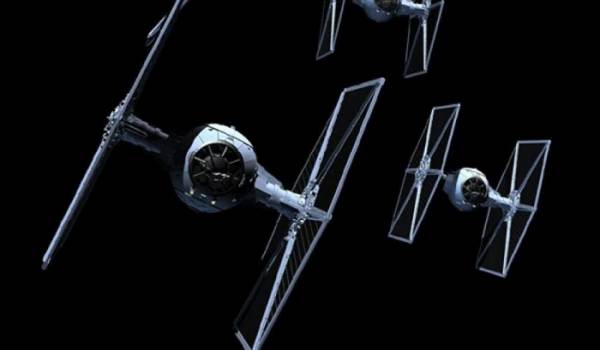 A squadron of Star Wars starship TIE Fighters flying in a tight formation.