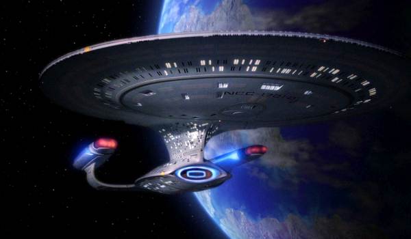 Underside view of the Star Trek starship USS Enterprise NCC-1701-D against a planetary backdrop.