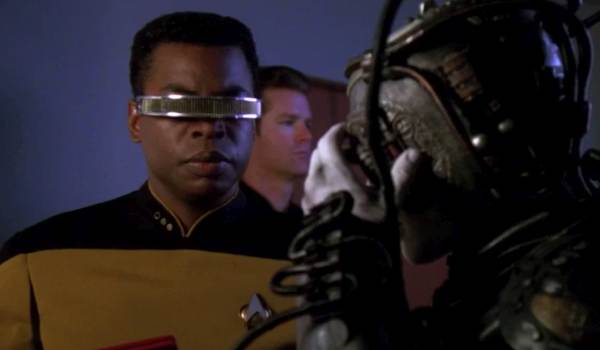 LeVar Burton, as Geordi La Forge, observes the Borg drone Hugh showcasing his iconic VISOR that fans love.