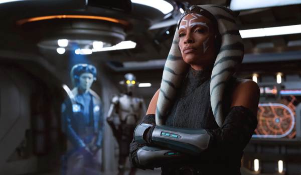 Ahsoka Tano (Rosario Dawson) standing with arms crossed on the bridge of a starship, with Hera Syndulla and Huyang in the background, from the 2023 series Ahsoka.