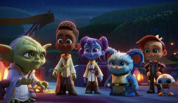 Master Yoda (voiced by Piotr Michael) speaks to young Jedi initiates Kai Brightstar, Lys Solay, and Nubs, along with their friends Nash Durango and RJ-83, in the 2023 animated series Star Wars: Young Jedi Adventures.