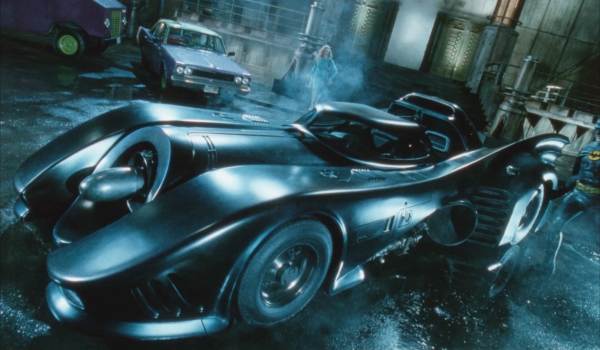 Playing Batman and Vicki Vale, Michael Keaton and Kim Basinger leave the Flugenheim Museum and see the Batmobile gleaming in the night.