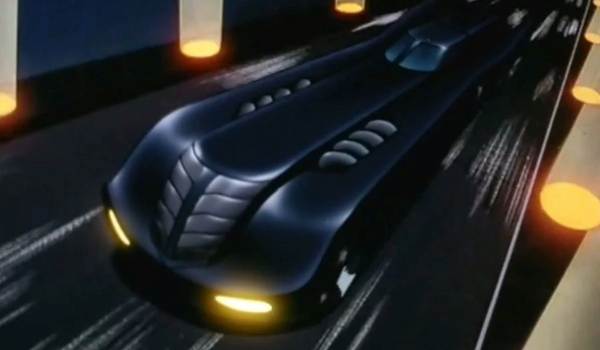 The Batmobile racing down a city street in Batman: The Animated Series