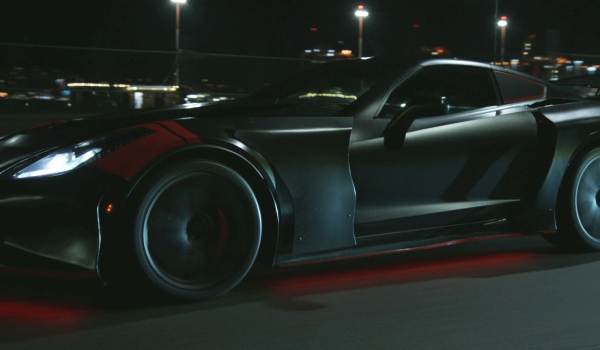 The C7 Chevrolet Corvette Batmobile from Batwoman driving down the road showing red accent lighting
