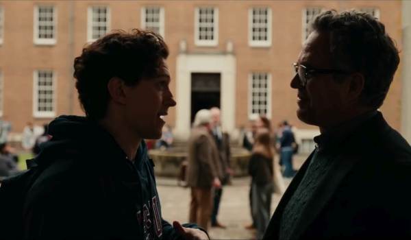 Peter Parker (Tom Holland) and Bruce Banner (Mark Ruffalo) in profile conversation in an outdoor university courtyard in a scene from Spider-Man: Brand New Day.