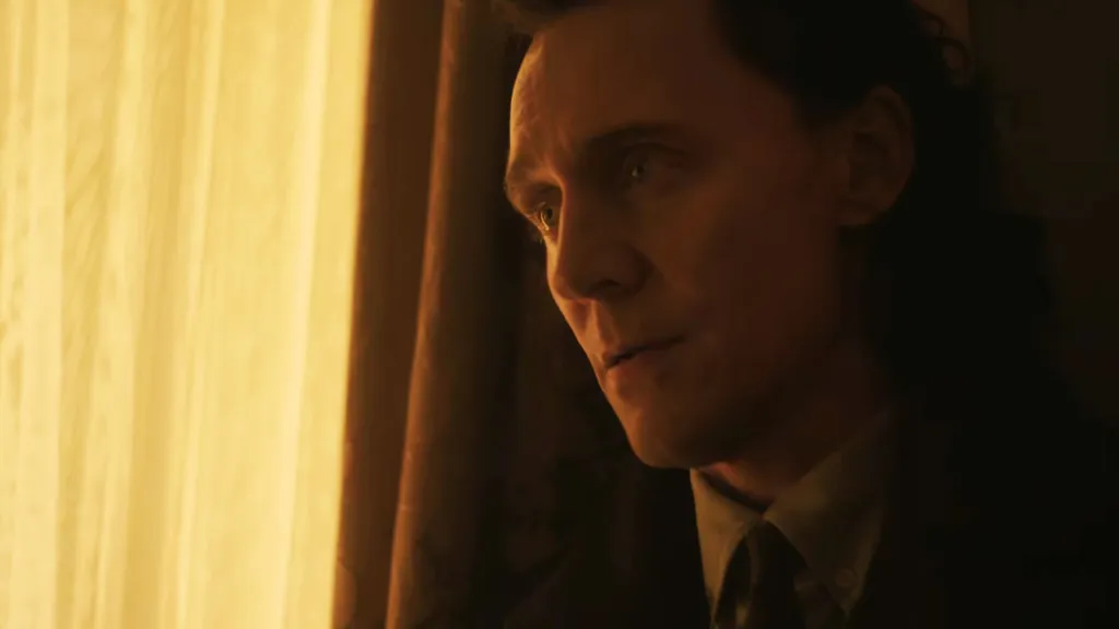 Tom Hiddleston as Loki looking out a window in Avengers: Doomsday.
