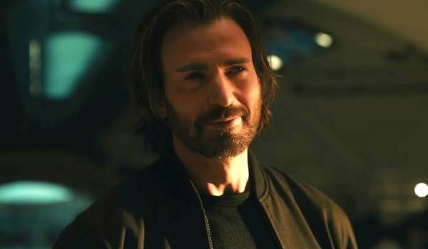 Chris Evans as Steve Rogers smiling in a dark jacket in Avengers: Doomsday.