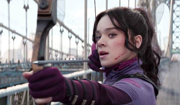 Hailee Steinfeld as Kate Bishop aiming her bow and arrow on a bridge in the Marvel series Hawkeye.