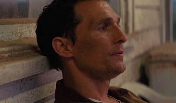 Matthew McConaughey as Cooper sitting on his porch in the 2014 sci-fi film Interstellar.