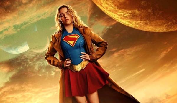 Milly Alcock as Supergirl standing confidently against an extraterrestrial sky featuring a large planet and moons in the 2026 film Supergirl.
