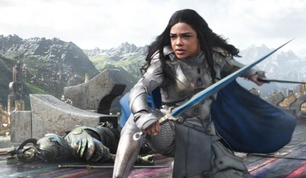 Tessa Thompson as Valkyrie in battle armor holding a sword in the Marvel movie Thor: Ragnarok.