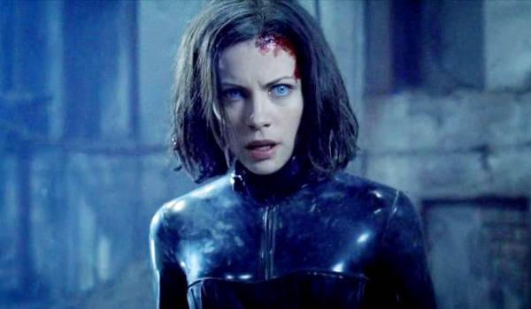Kate Beckinsale as the vampire death dealer Selene with piercing blue eyes and a head wound in the action film Underworld.