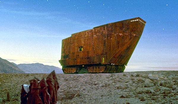Hooded Jawas standing before the Sandcrawler vehicle at dusk, Star Wars A New Hope